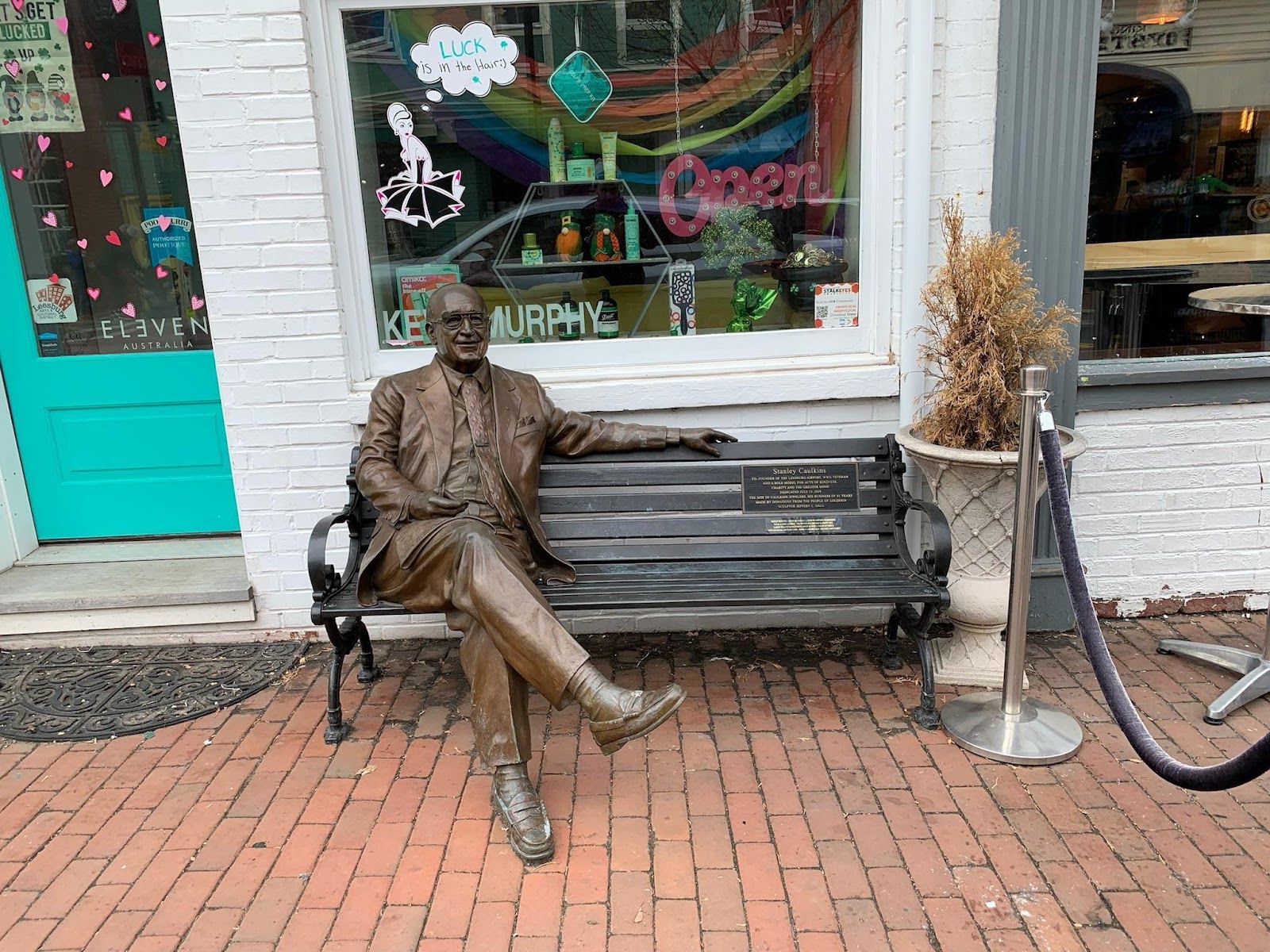Sculpture of Stanley Caulkins sitting on a bench